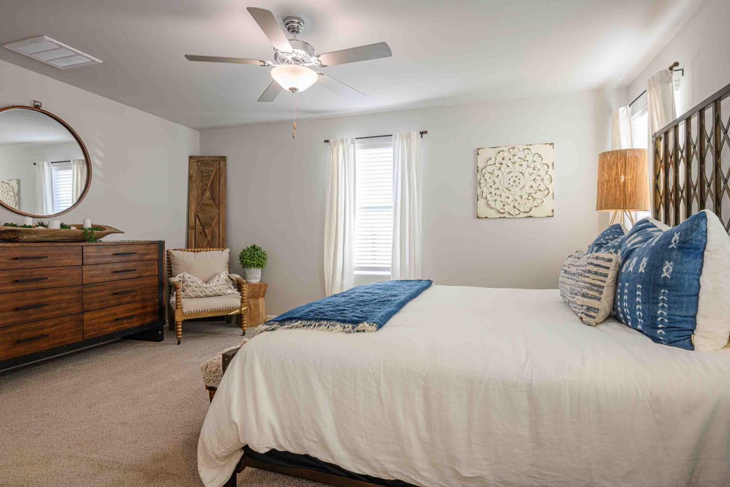 64 River Oak Court, Unit 47 Merced, CA 95341 - Photo 11 of 18 a bedroom with a bed dresser and a window