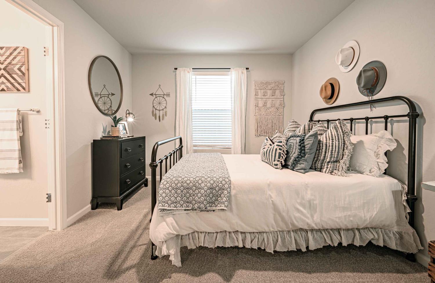 64 River Oak Court, Unit 47 Merced, CA 95341 - Photo 14 of 18 a bedroom with a bed and a chandelier