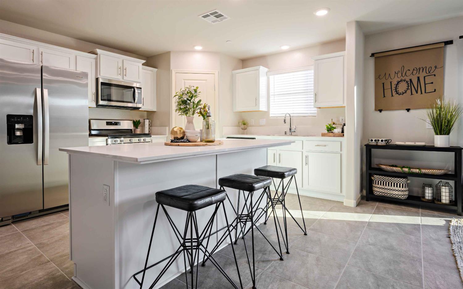 64 River Oak Court, Unit 47 Merced, CA 95341 - Photo 2 of 18 a kitchen with stainless steel appliances granite countertop a table and chairs in it