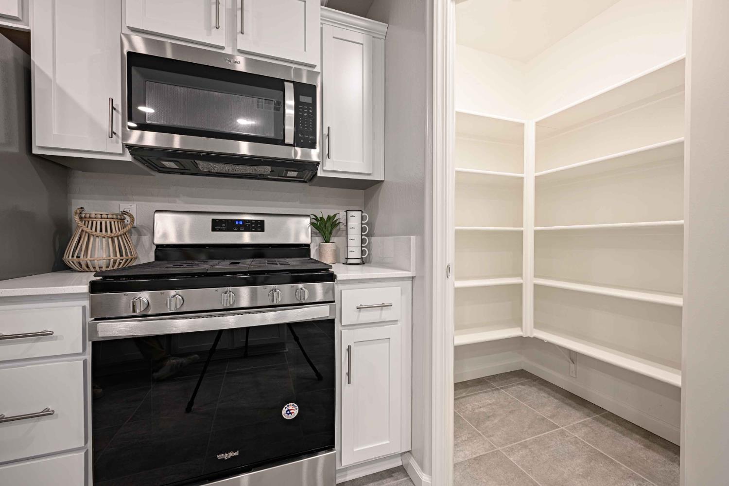 64 River Oak Court, Unit 47 Merced, CA 95341 - Photo 5 of 18 a kitchen with stainless steel appliances a stove microwave and cabinets