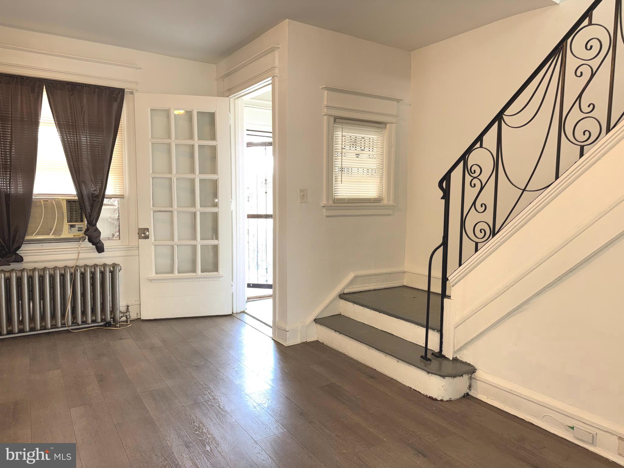5756 Hunter Street Philadelphia, PA 19131 - Photo 6 of 16 a view of an entryway with wooden floor and door