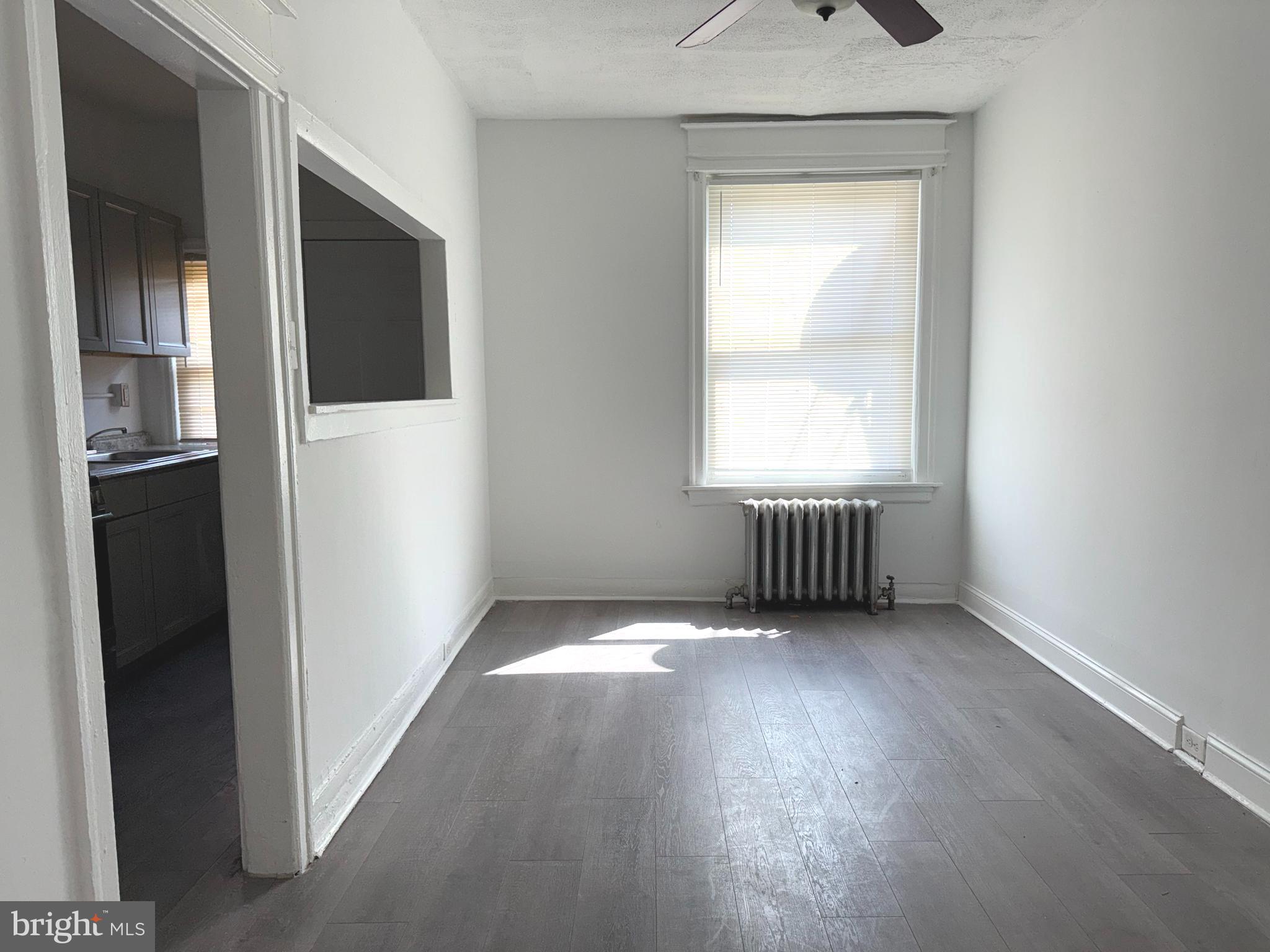 5756 Hunter Street Philadelphia, PA 19131 - Photo 7 of 16 a view of an empty room with wooden floor and a window