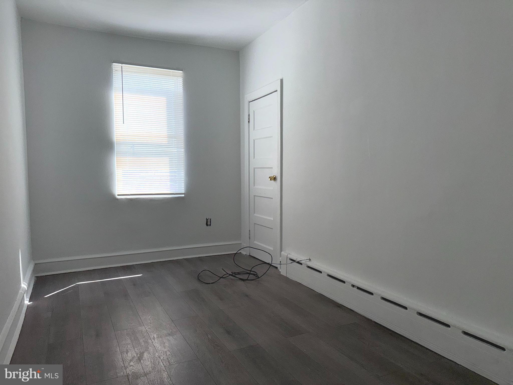 5756 Hunter Street Philadelphia, PA 19131 - Photo 9 of 16 an empty room with wooden floor and windows