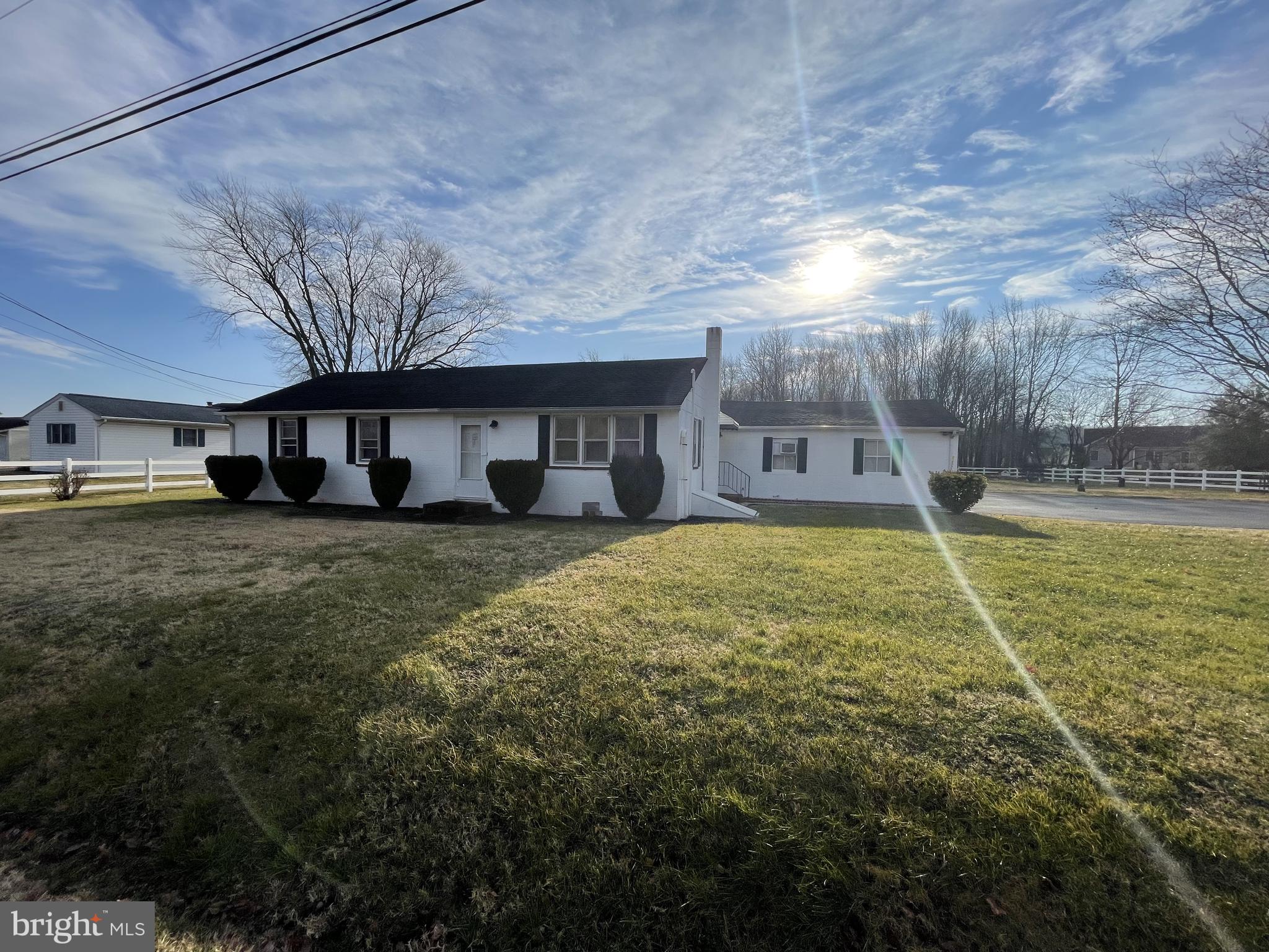 4420 West Denneys Road Dover, DE 19904 - Photo 1 of 36 a front view of a house with a yard