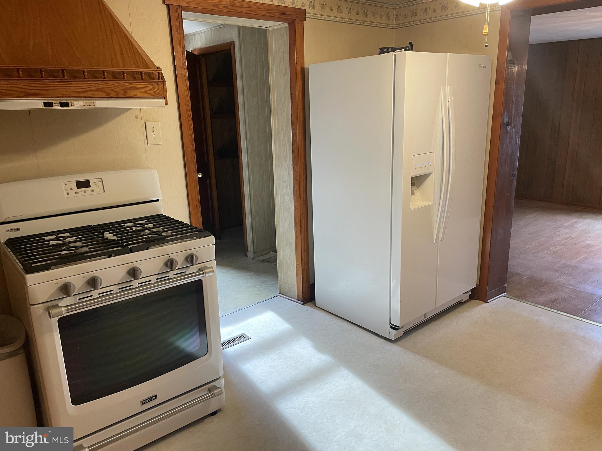 4420 West Denneys Road Dover, DE 19904 - Photo 16 of 36 a kitchen with a stove and a refrigerator