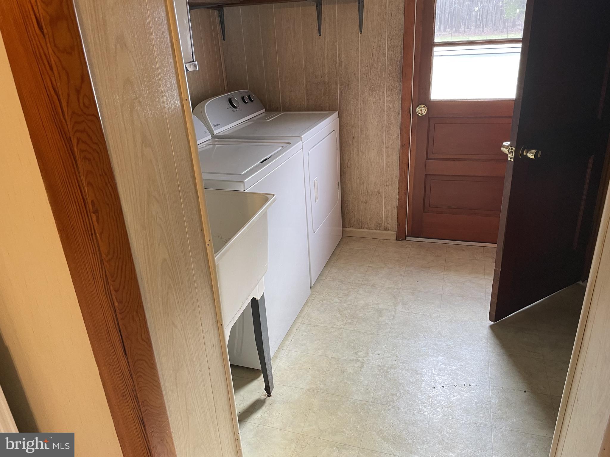 4420 West Denneys Road Dover, DE 19904 - Photo 18 of 36 a utility room with a sink a washer and dryer