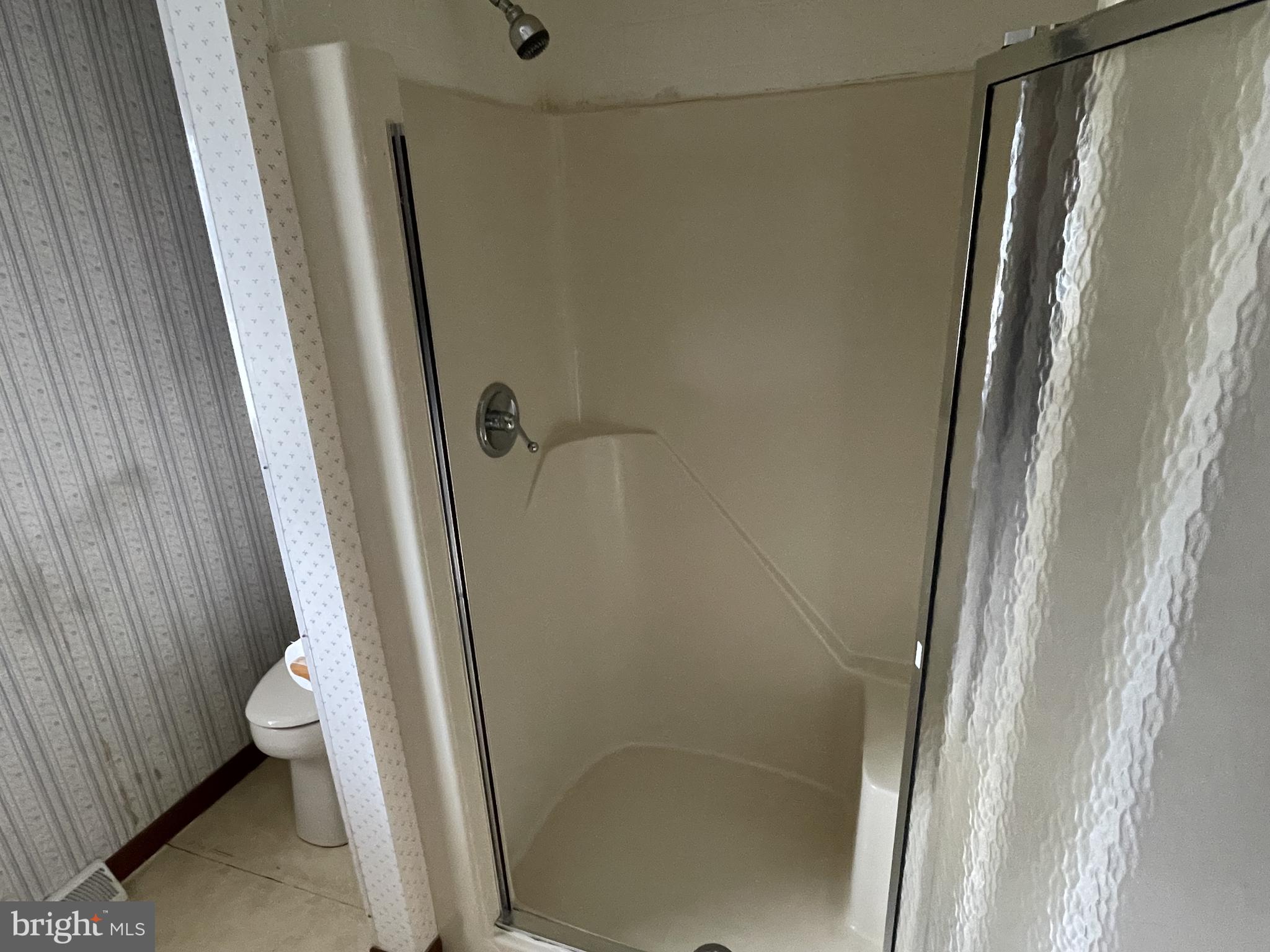 4420 West Denneys Road Dover, DE 19904 - Photo 32 of 36 a bathroom with a shower and a toilet