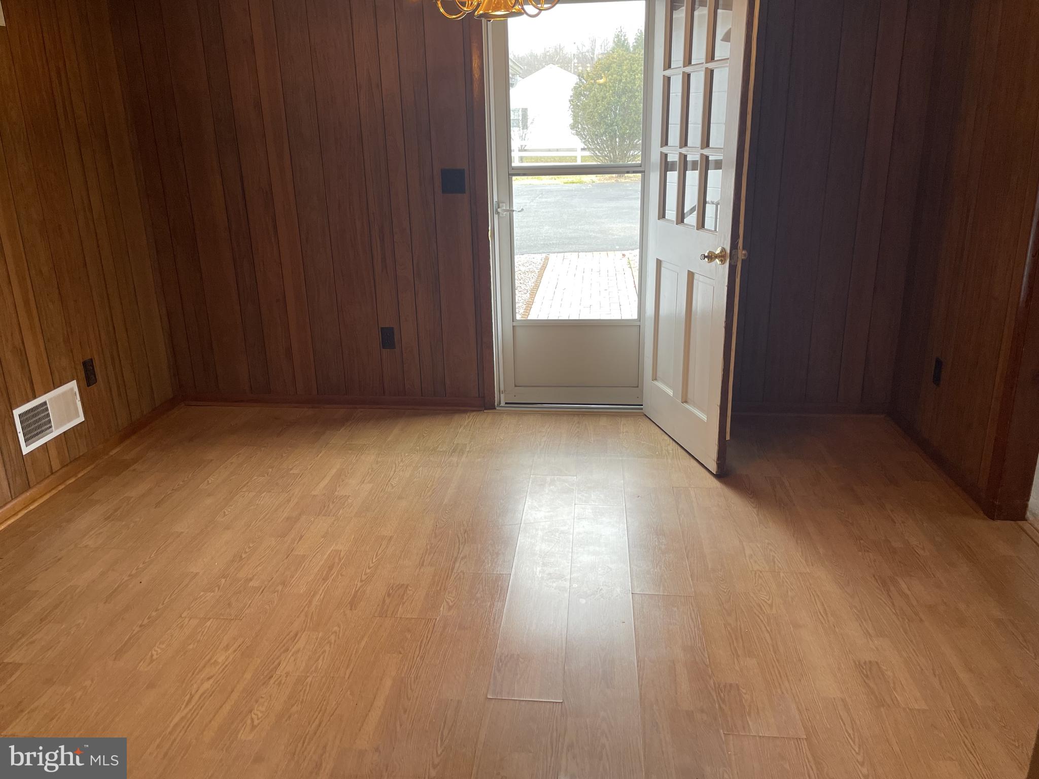 4420 West Denneys Road Dover, DE 19904 - Photo 8 of 36 an empty room with wooden floor and windows