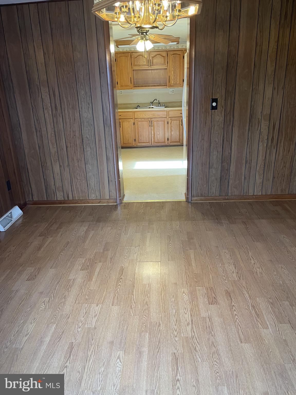 4420 West Denneys Road Dover, DE 19904 - Photo 10 of 36 a view of a room with wooden floor and a kitchen space