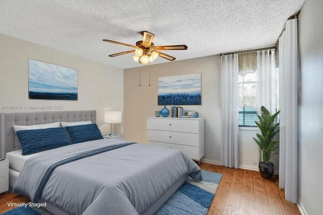 a bedroom with a bed and a potted plant