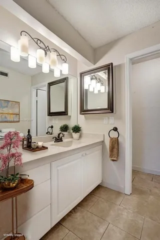 a bathroom with a sink a mirror and a bathtub