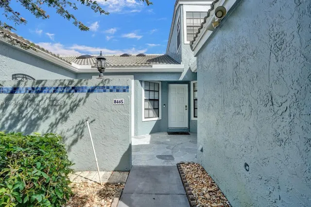 a view of a brick house with a large tree