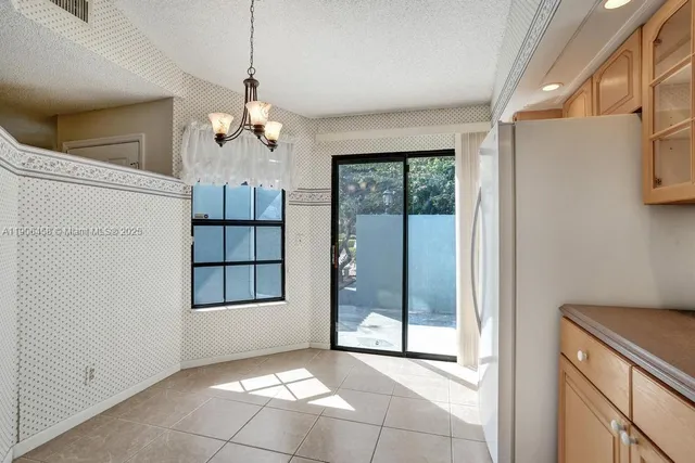 a view of a room with window and chandelier