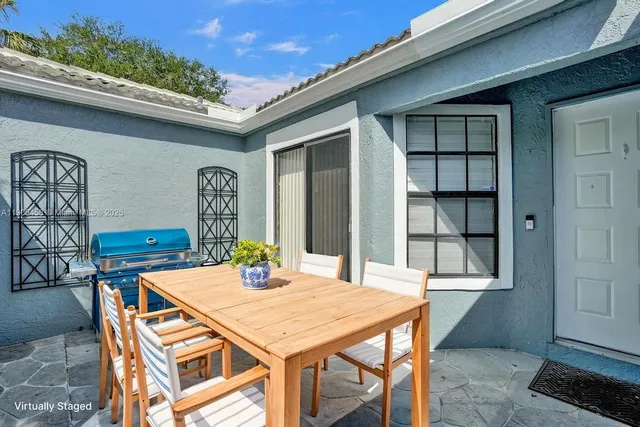 a view of a dining table and chairs in balcony