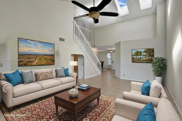 a living room with furniture a rug and a window