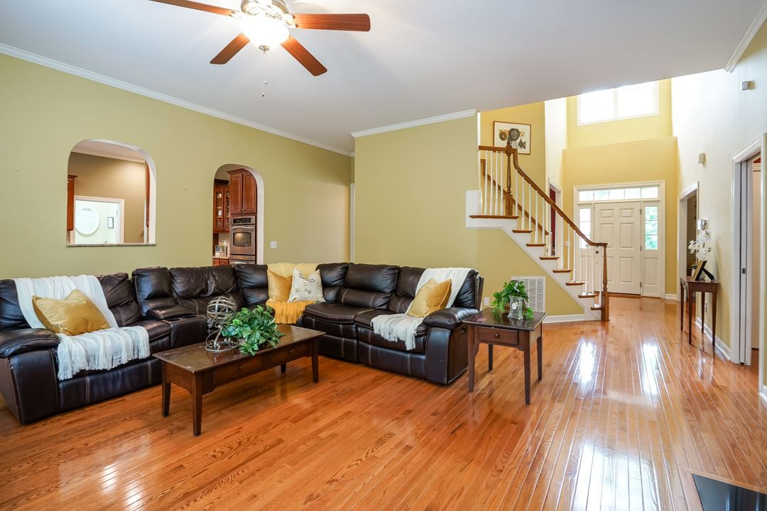 The gleaming hardwood floors continue into the large family room. This view looks back towards the two-story foyer and front door. Family Room
