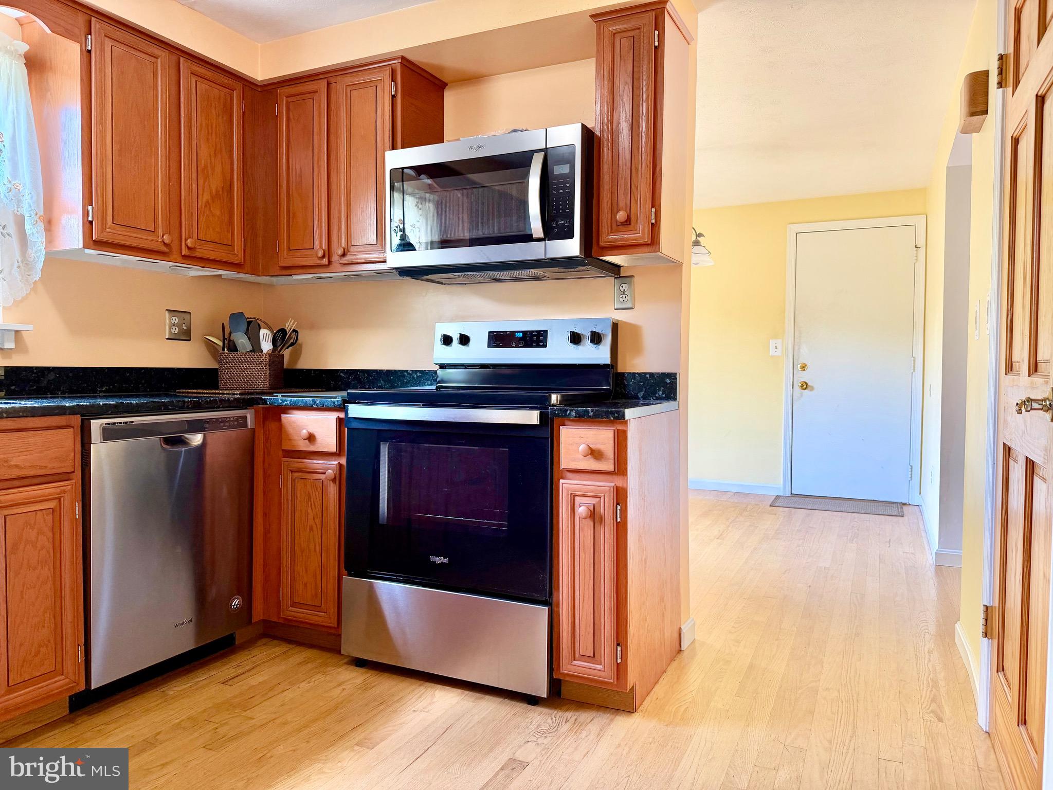 2712 Parallel Path Abingdon, MD 21009 - Photo 12 of 37 a kitchen with stainless steel appliances granite countertop a stove a microwave and a refrigerator