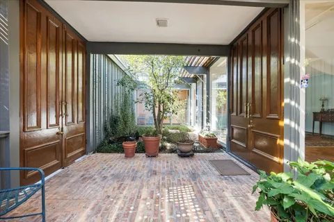 a balcony with furniture and a potted plant