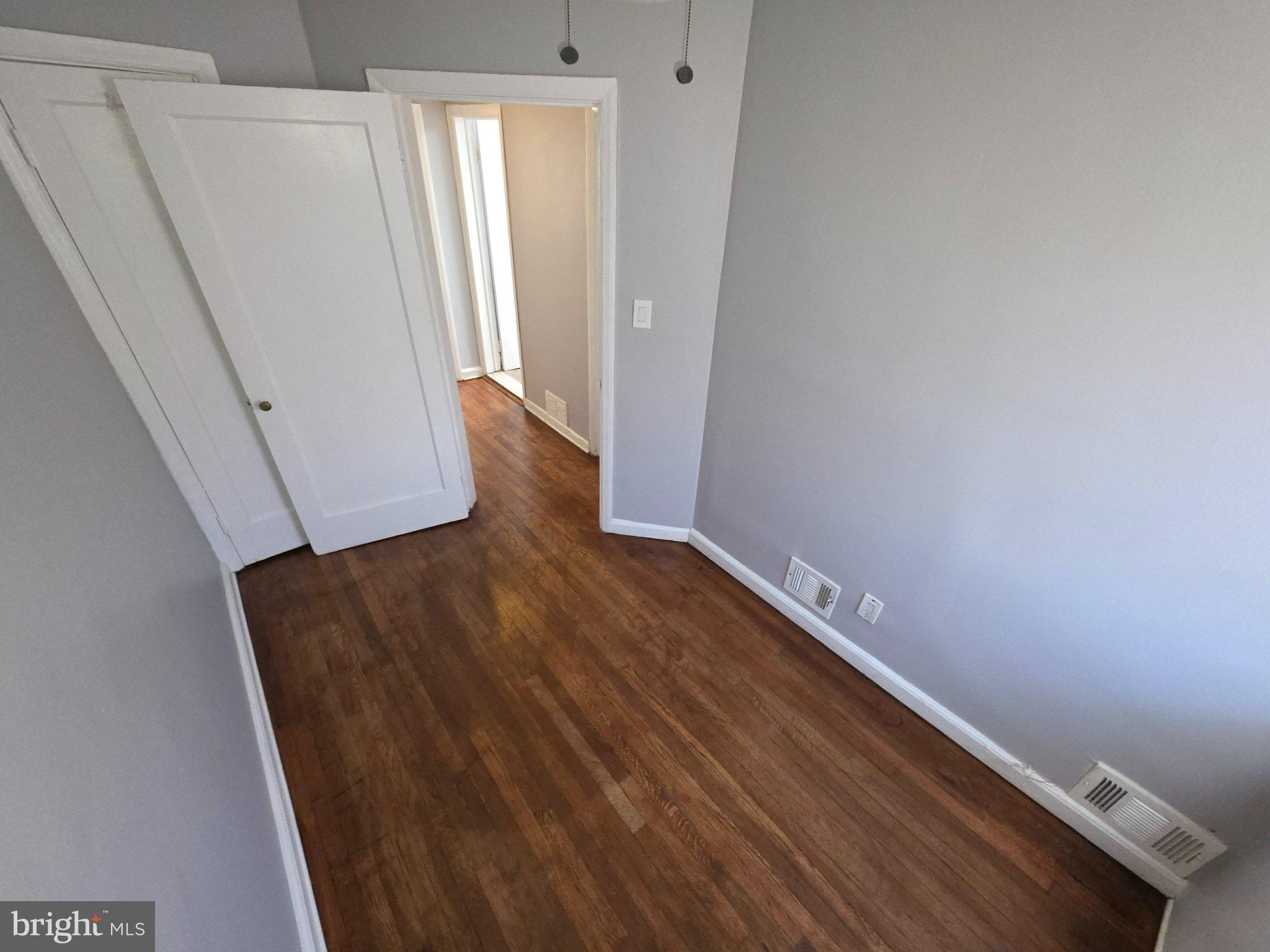 4404 Mountview Road Baltimore, MD 21229 - Photo 17 of 22 a view of a hallway with wooden floor