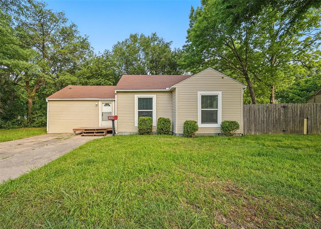 1003 Pecan Avenue Greenville, TX 75401 - Photo 1 of 25 a view of a yard in front of a house with large trees