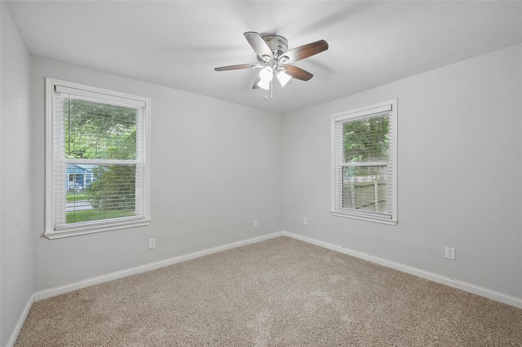 1003 Pecan Avenue Greenville, TX 75401 - Photo 14 of 25 an empty room with a window and a fan