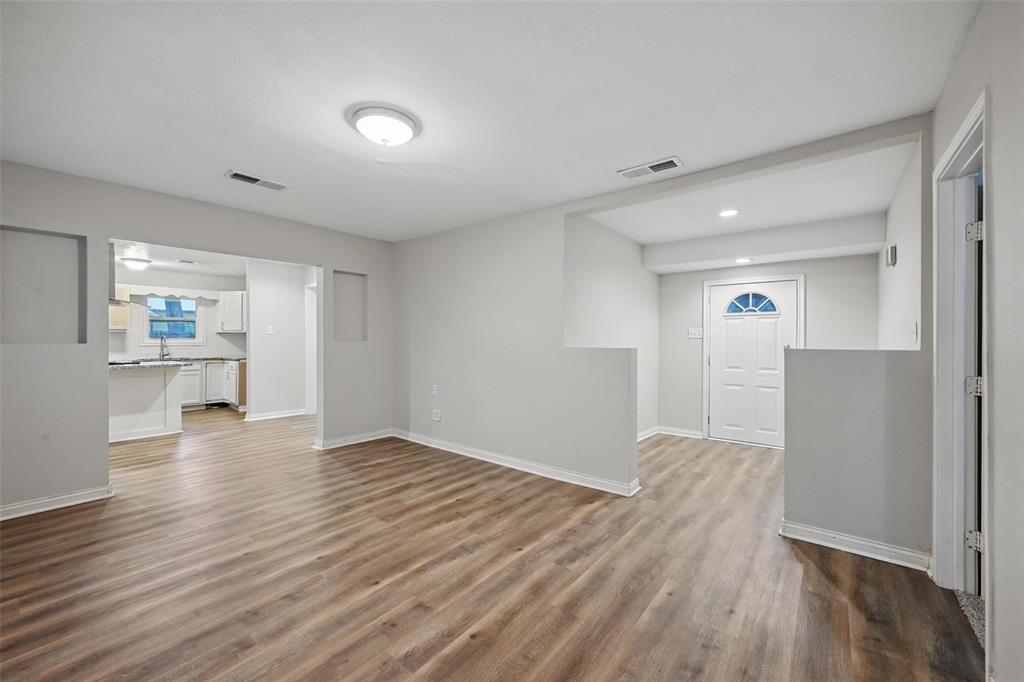 1003 Pecan Avenue Greenville, TX 75401 - Photo 2 of 25 a view of empty room with wooden floor