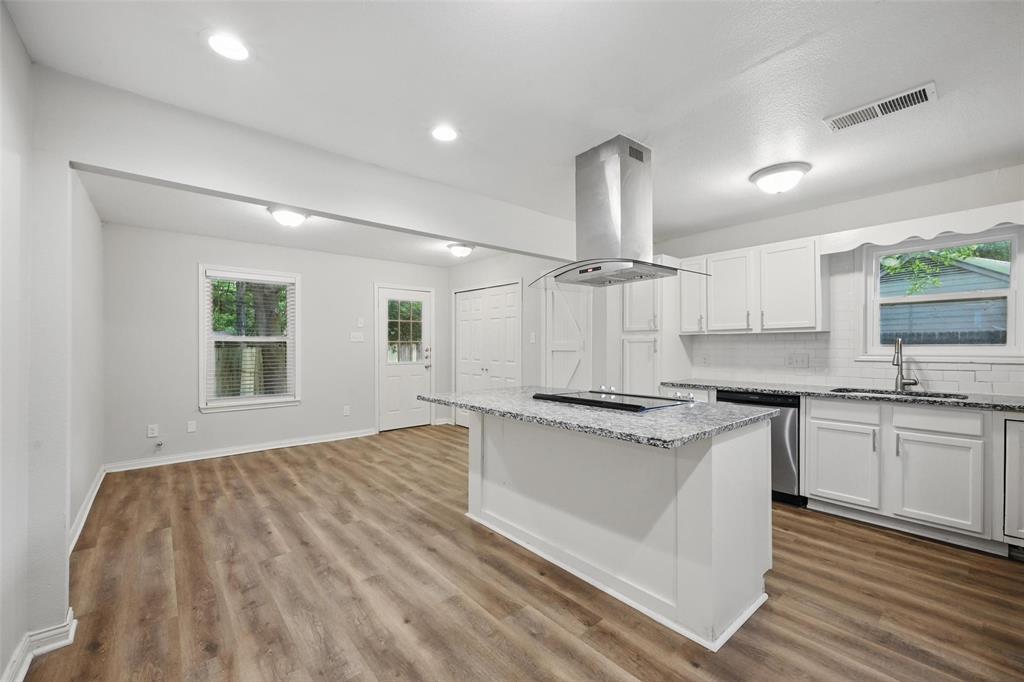 1003 Pecan Avenue Greenville, TX 75401 - Photo 7 of 25 a kitchen with stainless steel appliances granite countertop a sink stove and refrigerator