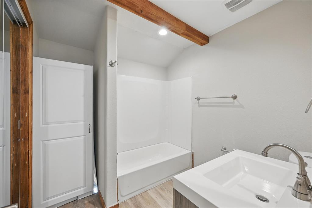 1003 Pecan Avenue Greenville, TX 75401 - Photo 8 of 25 a bathroom with a sink and a bathtub