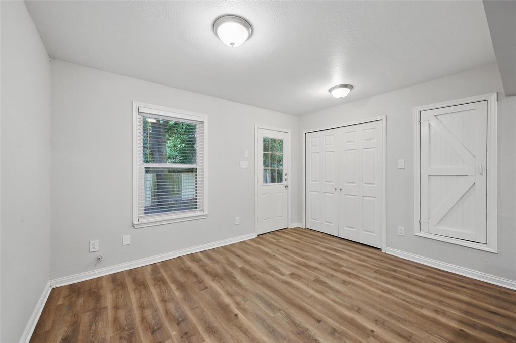 1003 Pecan Avenue Greenville, TX 75401 - Photo 10 of 25 an empty room with windows