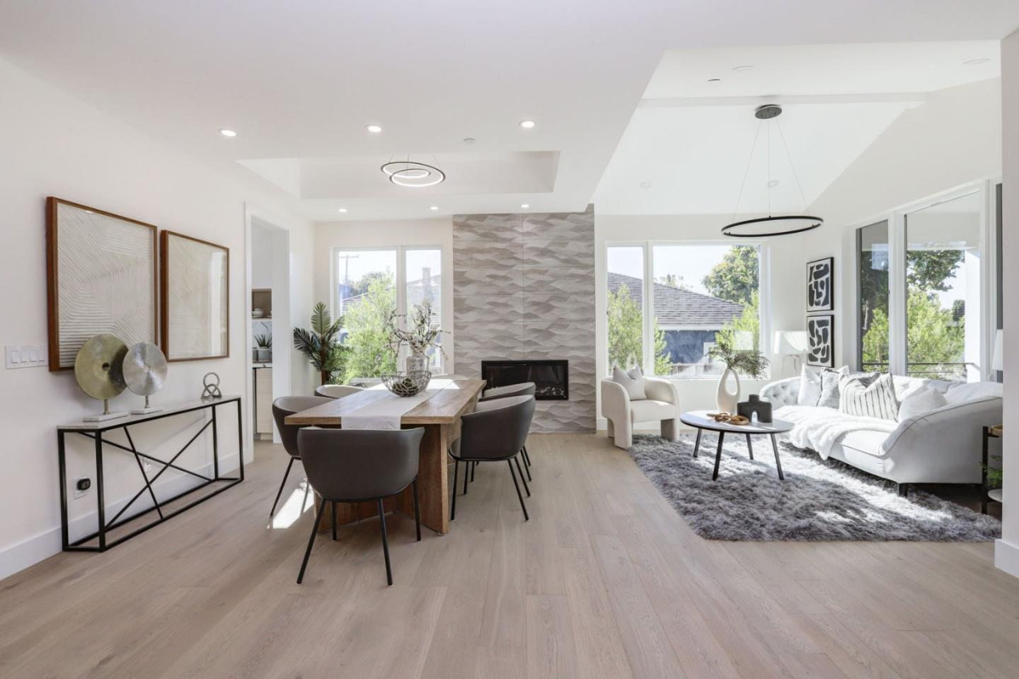 3107 Greer Road Palo Alto, CA 94303 - Photo 1 of 20 a living room with furniture a fireplace and a floor to ceiling window