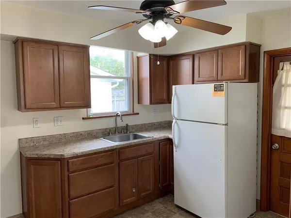 a kitchen with a sink a refrigerator and window