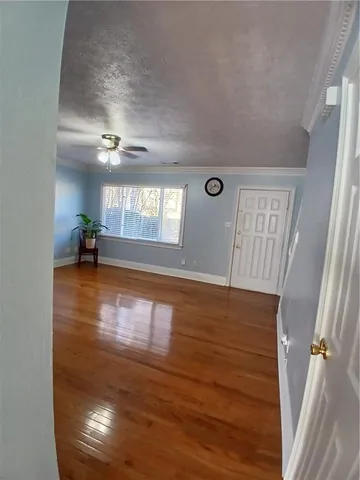 a view of entryway and hall with wooden floor