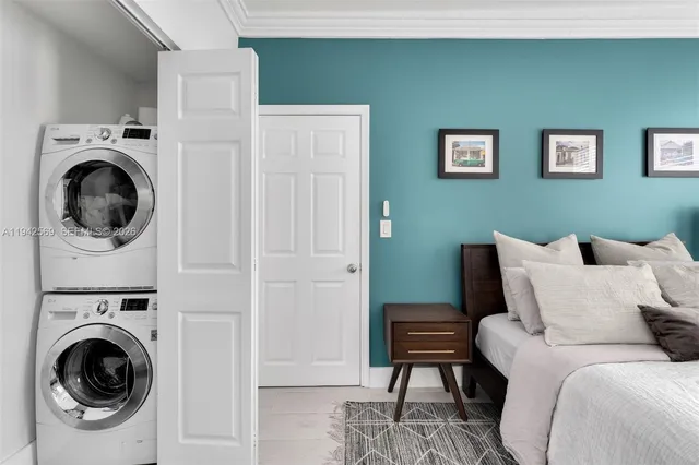 a bedroom with a bed and a washing machine