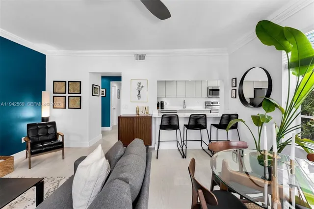 a living room with furniture a rug and a window
