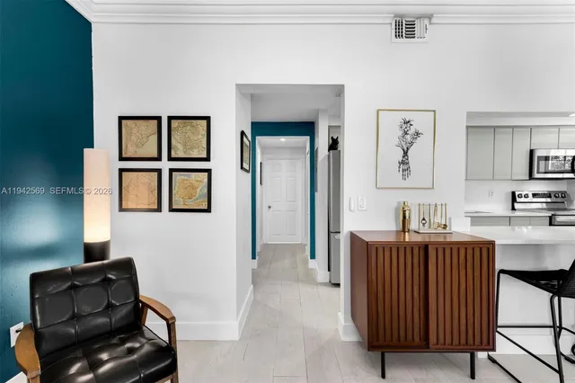 a living room with furniture and a dresser
