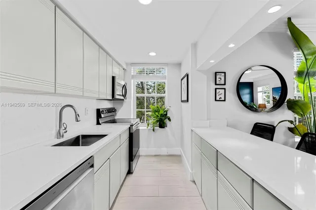a kitchen with a sink cabinets and a stove