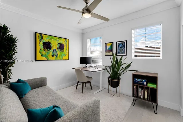 a living room with furniture a chandelier and a potted plant