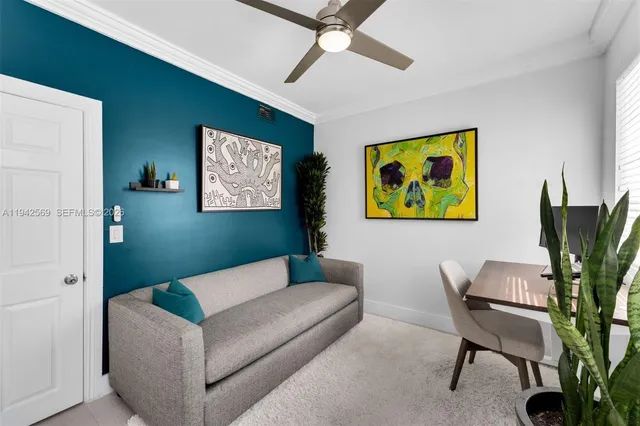 a living room with furniture and a potted plant