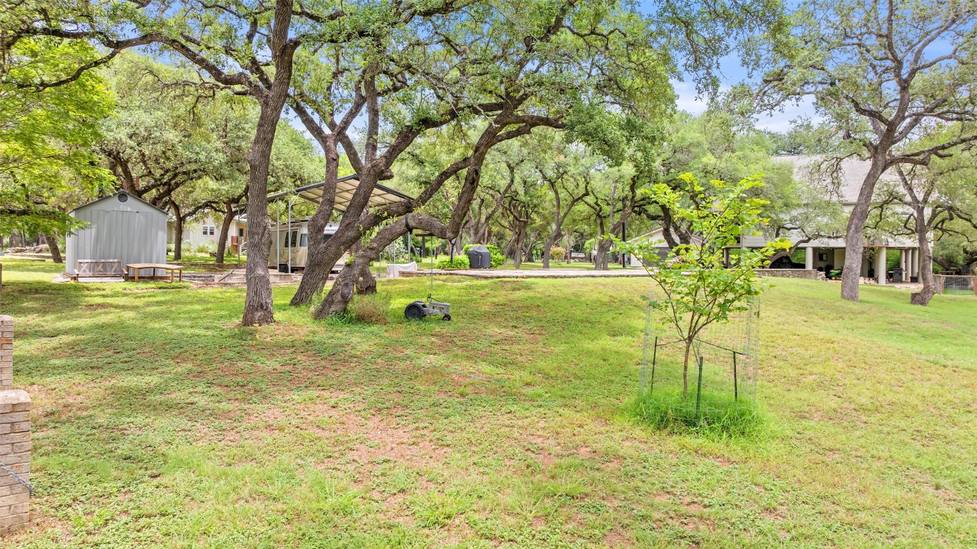 200 Rim Road Wimberley, TX 78676 - Photo 25 of 25 View of grassy yard featuring a storage shed