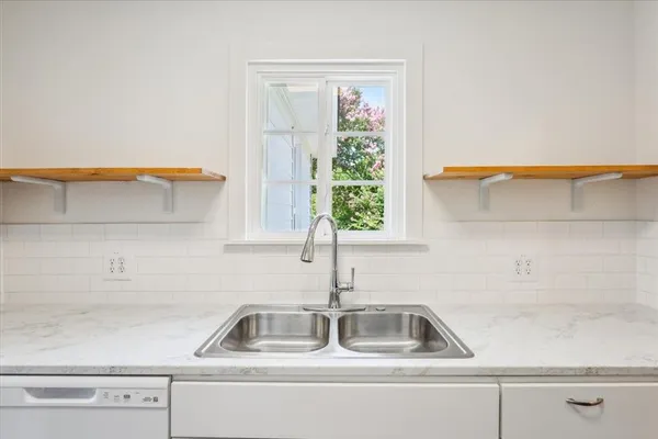 a kitchen that has a sink and a window