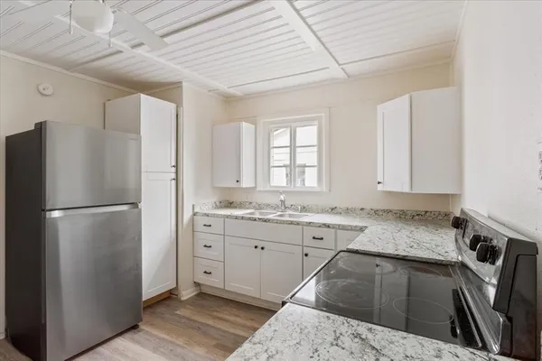 a kitchen with a refrigerator and a sink