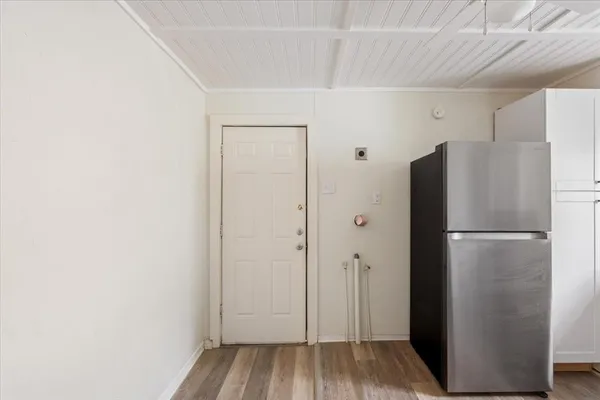 a view of a refrigerator in kitchen and wooden floor