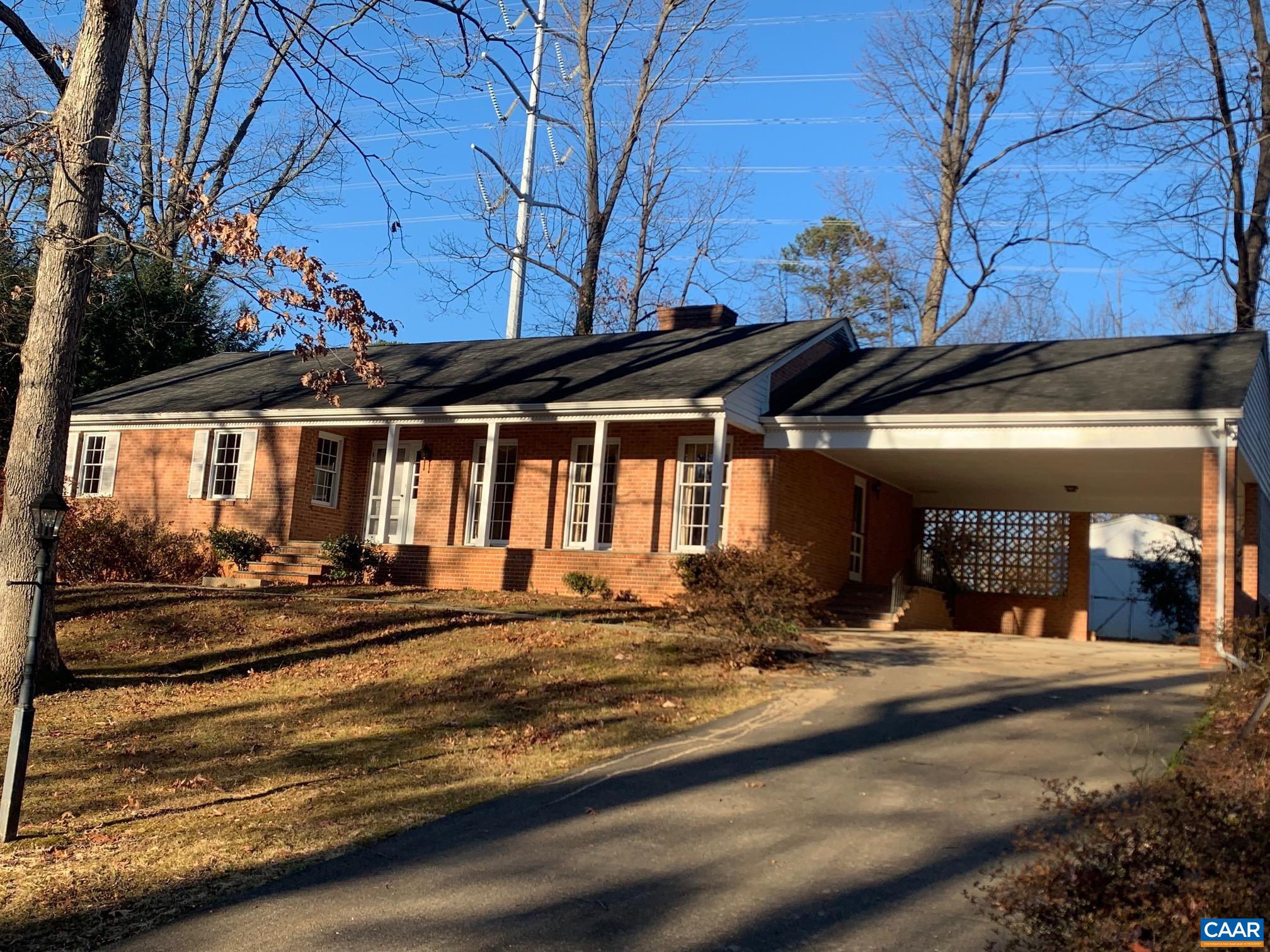 2420 Angus Road Charlottesville, VA 22901 - Photo 1 of 46 a view of a house with large windows and a tree