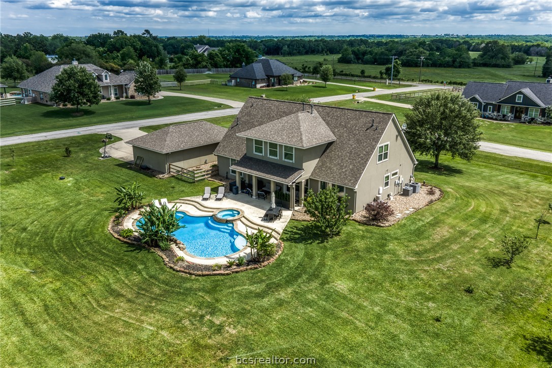 586 Ruby Drive Bellville, TX 77418 - Photo 45 of 50 a aerial view of a house with a yard table and chairs