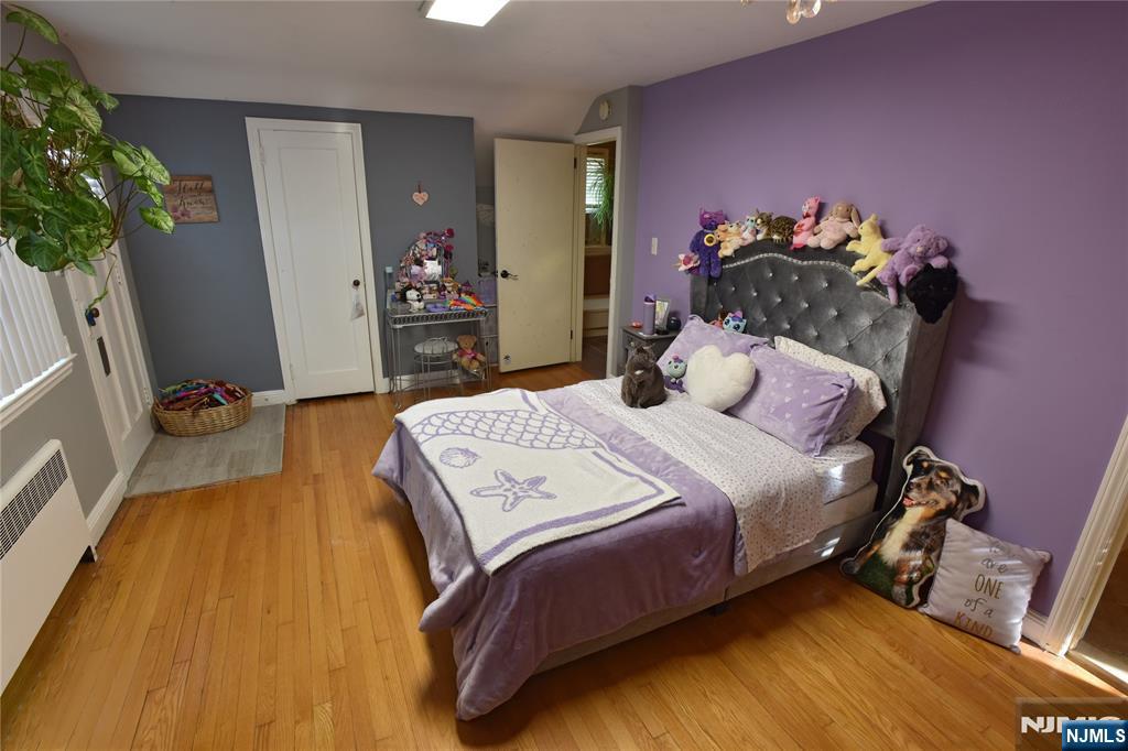 585 Monroe Place Ridgefield, NJ 07657 - Photo 16 of 28 a bedroom with a bed and a potted plant