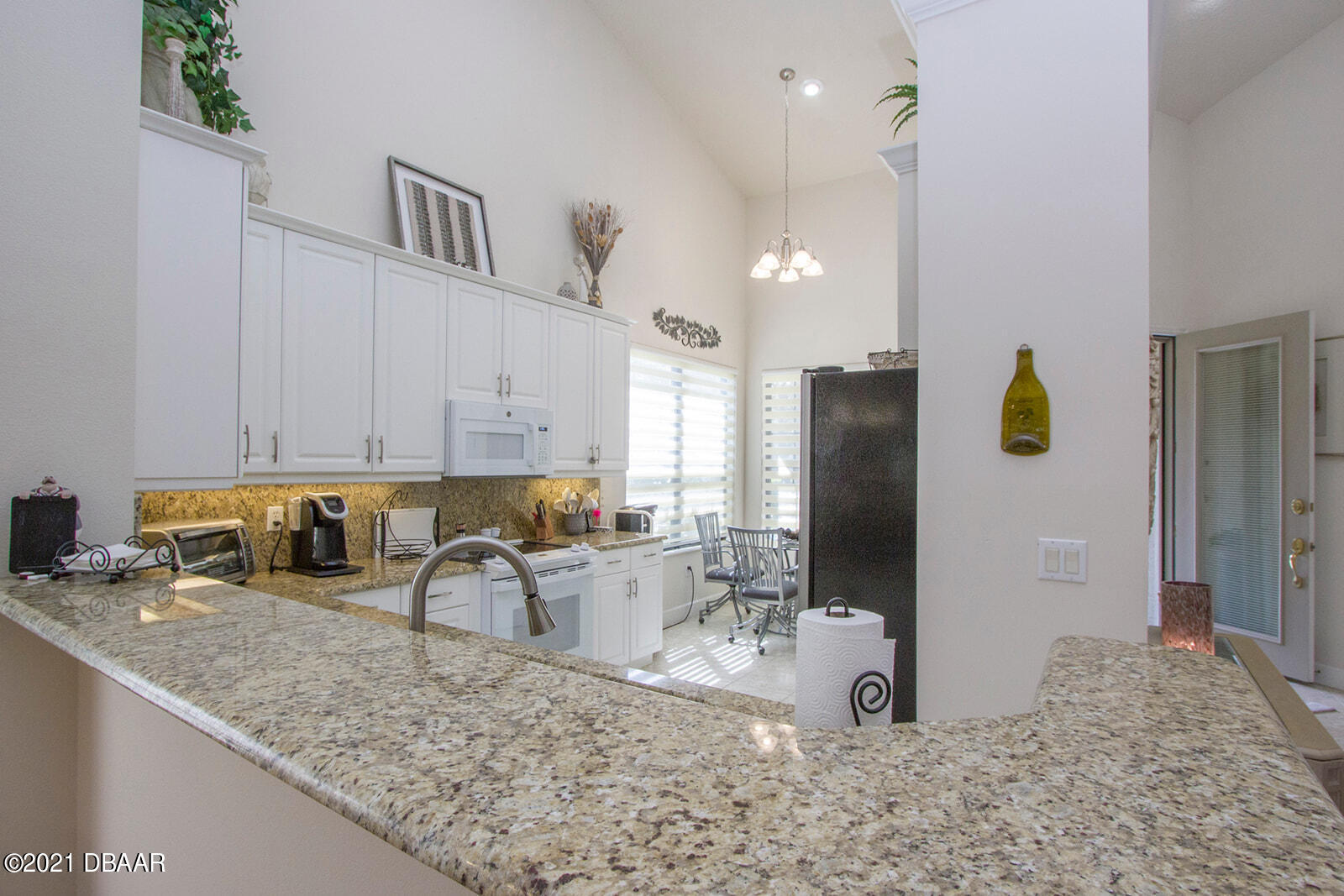 751 Cobblestone Way Ormond Beach, FL 32174 - Photo 9 of 63 a kitchen with stainless steel appliances granite countertop a sink refrigerator and cabinets