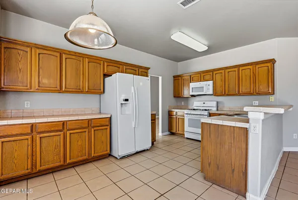 a kitchen with stainless steel appliances granite countertop a refrigerator sink and cabinets