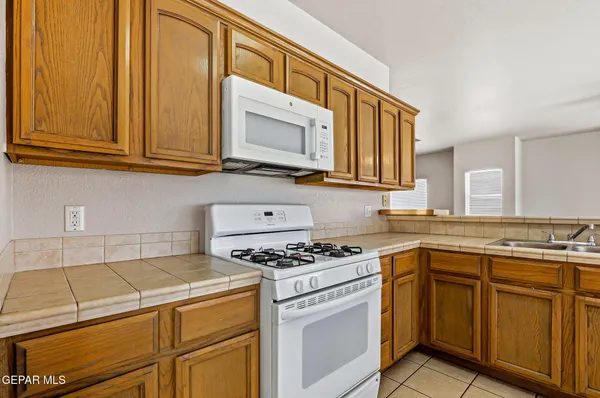 a kitchen with granite countertop cabinets stainless steel appliances and a sink