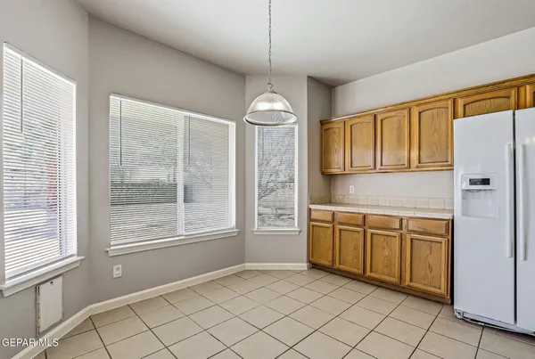 a kitchen with a refrigerator a sink and cabinets