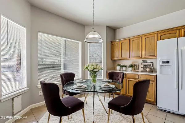 a dining room with furniture a chandelier and wooden floor